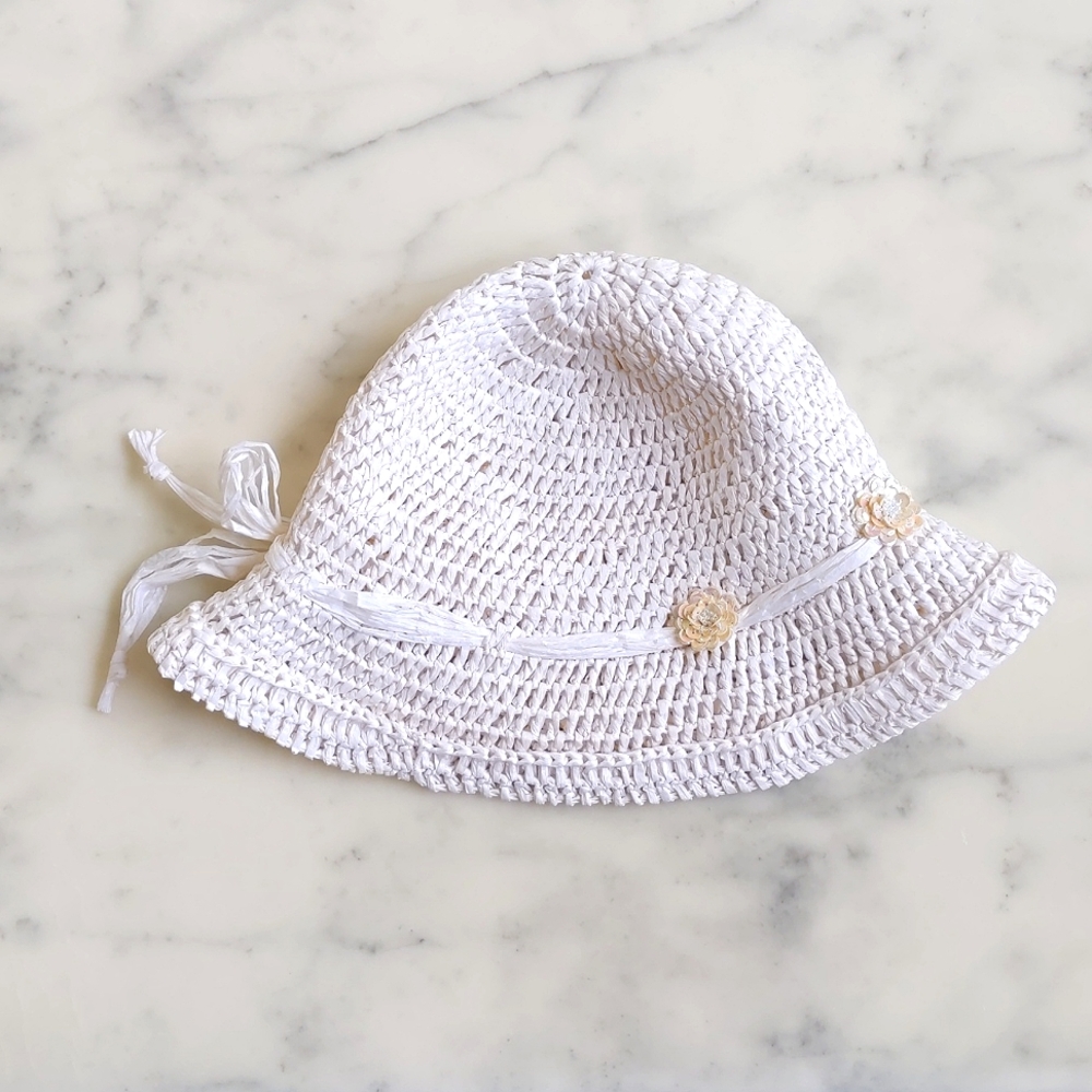 NWOT. 100% Paper Straw Hat with beads and sparkling flowers decorations.